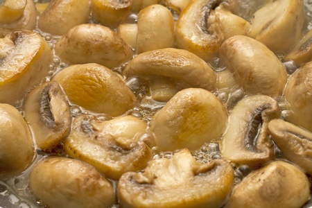 Mushrooms frying in hot oilの写真素材