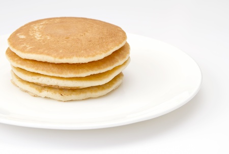 Four pancakes on a white plateの写真素材