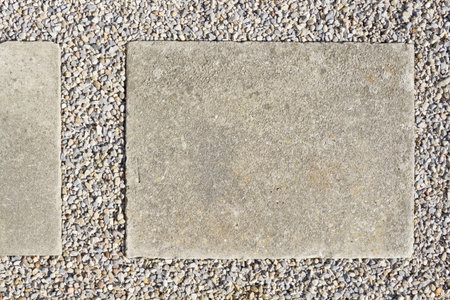Concrete paving slap with gravel surround 