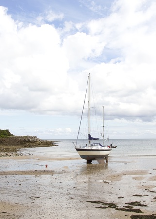 Yacht on sandy beach の写真素材