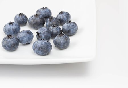 Blueberries on a white square plateの写真素材