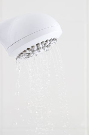 Water flowing slowly from white plastic shower headの写真素材