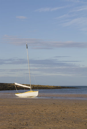 Small dinghy on beach in evening sun