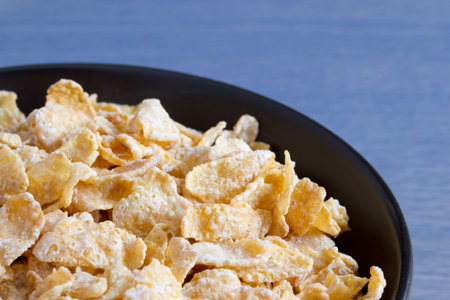 Black bowl with frosted cereal flakes