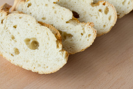 Sliced fresh baguette on a wooden board