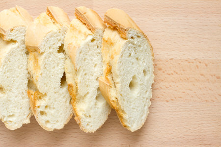 Sliced fresh baguette on a wooden board