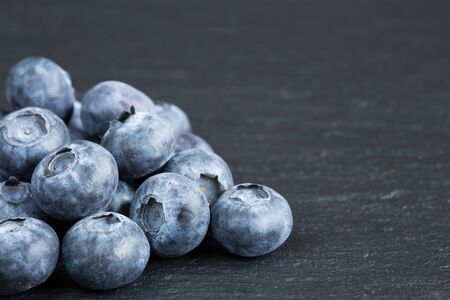 Ripe blueberries on slateの写真素材
