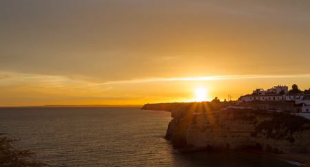 Beautiful golden sunset over Carvoeiro in Portugalの写真素材