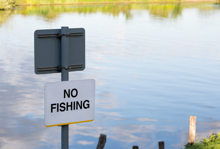 No fishing sign at the side of the River Thamesの写真素材