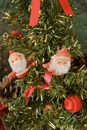 Two little Santa Klaus standing on a Christmas treeの写真素材