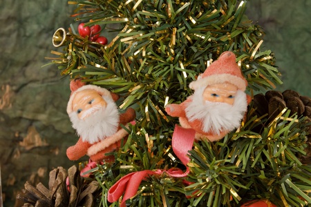 Two little Santa Klaus standing on a Christmas treeの写真素材