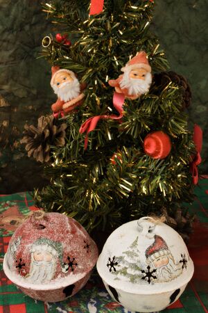 Two little Santa Klaus standing on a Christmas treeの写真素材