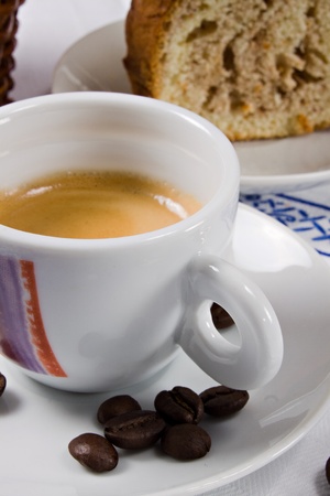 A cup of espresso coffee and a piece of cake for a perfect breakfastの写真素材