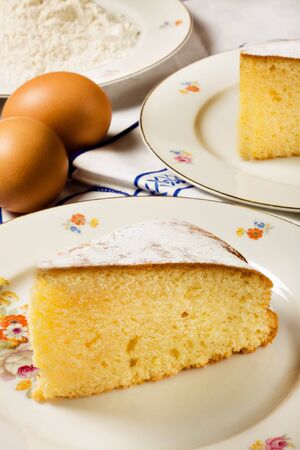 A slice of homemade lemon cake and ingredientsの写真素材