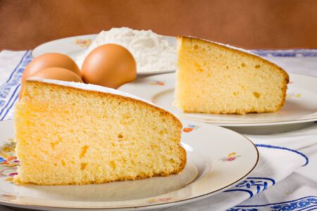 Slices of an homemade lemon cake and ingredients.の写真素材