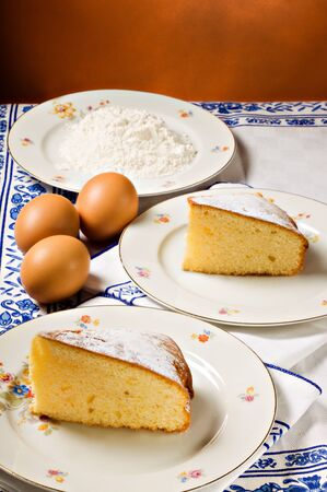Cake slices and ingredients, eggs and flour.の写真素材