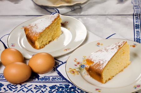 Two slices of an homemade lemon  cake and some eggs.の写真素材