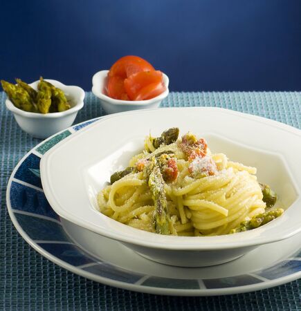 Italian pasta with tomatoes and asparagus の写真素材