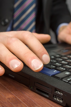 Businessman typing on a Personal Computer keyboardの写真素材