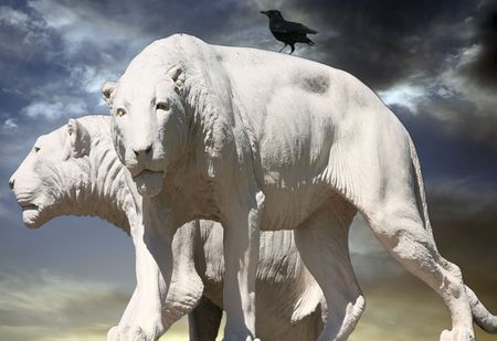 Statue of lions with dark sky and a crowの写真素材