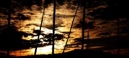 Sunset sky with sailboat masts