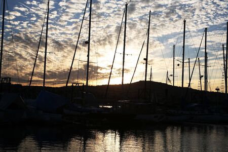 Shimmering water with sailboat mastsの写真素材