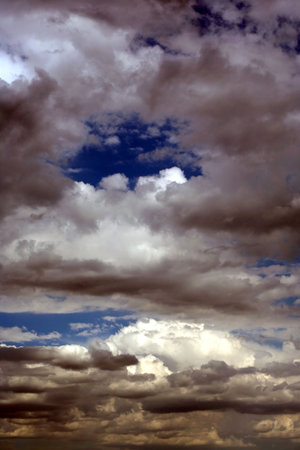 Daytime sky that has both beautiful blue sky and very dark clouds