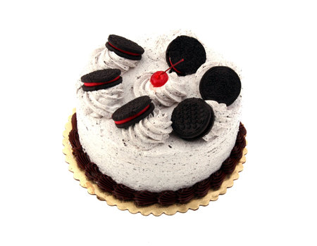 Cherry on top of a delicious chocolate cake with sandwich cookiesの写真素材