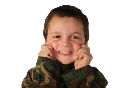 Young boy pinching his own cute cheeks with twinkling eyesの写真素材