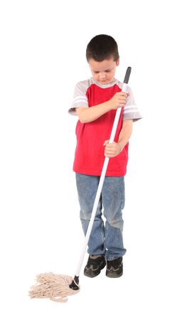 Young boy doing his chore of mopping the floorの写真素材