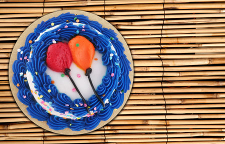 Delicious birthday party cake on a bamboo placemat