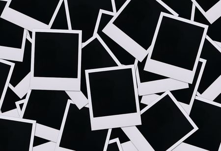 Old polaroid film blanks spread across a surfaceの写真素材