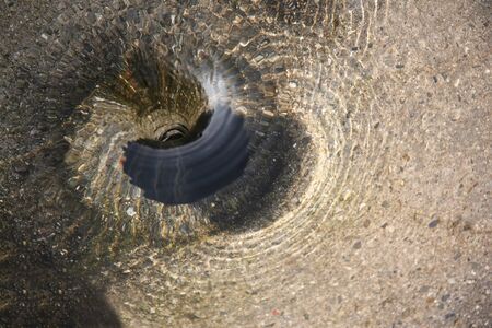 Natural background of a swirling water whirlpoolの写真素材