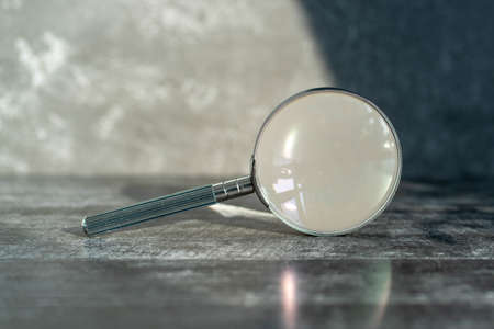 vintage magnifier on dark background, side view.の写真素材