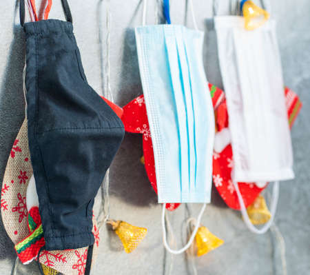 Horizontal color image with a view of Christmas decoration with coronavirus in the background, Christmas socks, face masks and toys. Covid concept for christmasの写真素材