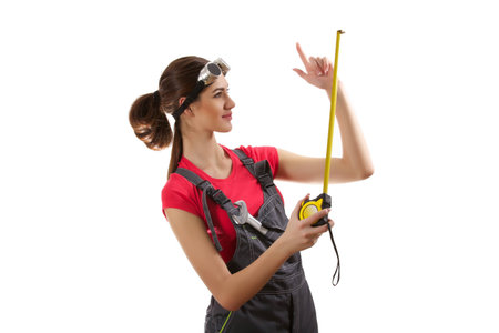 The girl stands with a measuring tape