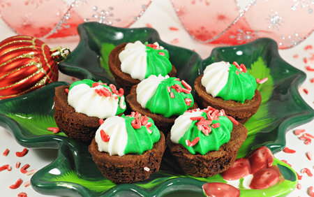 Tasty and decorated brownie on a colorful plate, Christmas decor, red ball, ribbonの写真素材