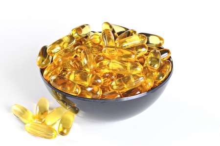 Bowl with Omega 3 (fish oil) pills, isolated on white backgroundの写真素材