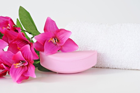 Rose soap, towel and flowers on white backgroundの写真素材