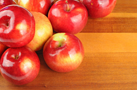 Red tasty apples on a wooden tableの写真素材
