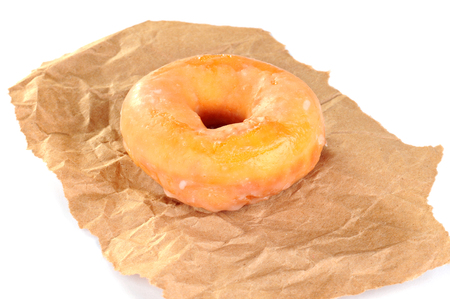 Delicious and fresh donut for breakfast, on a piece of brown paperの写真素材