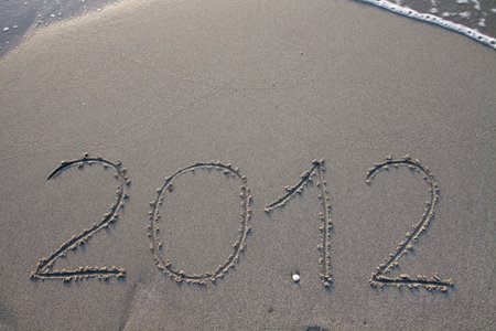 New year 2012 on the beach written on the sandの写真素材