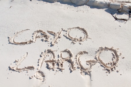Cayo Largo carved on the white sand of a beach in Cubaの写真素材