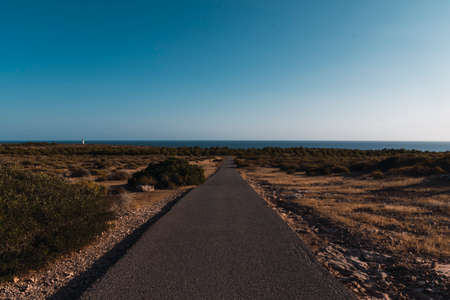 Empty road ends to the seaの写真素材