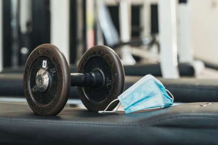 boy cleaning gym machines after using itの写真素材