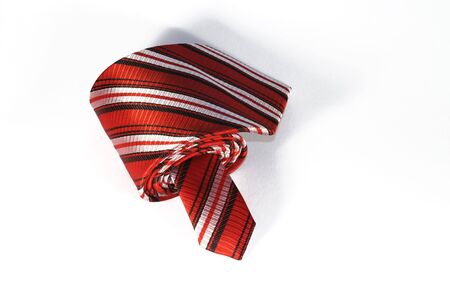 Striped red and white tie on white backgroundの写真素材