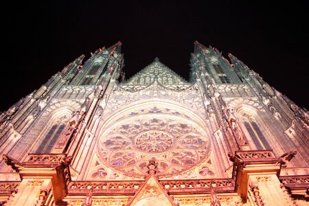 Prague's landmark cathedral lit up at night on the ground of the Prague castleの写真素材