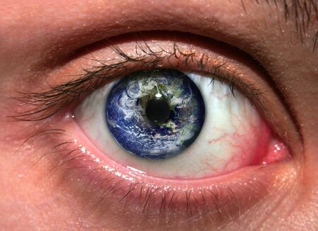 Planet Earth reflected in a woman's eye:の写真素材