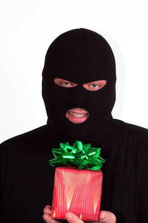 Criminal series 9 - masked bandit holding a wrapped Christmas giftの写真素材