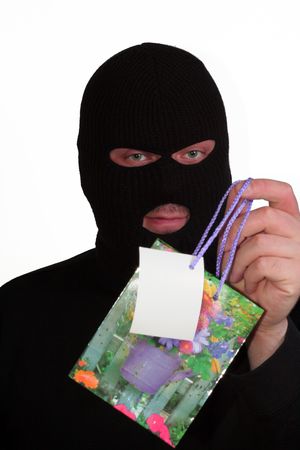 Criminal series 10 - smiling masked man holding a gift bagの写真素材